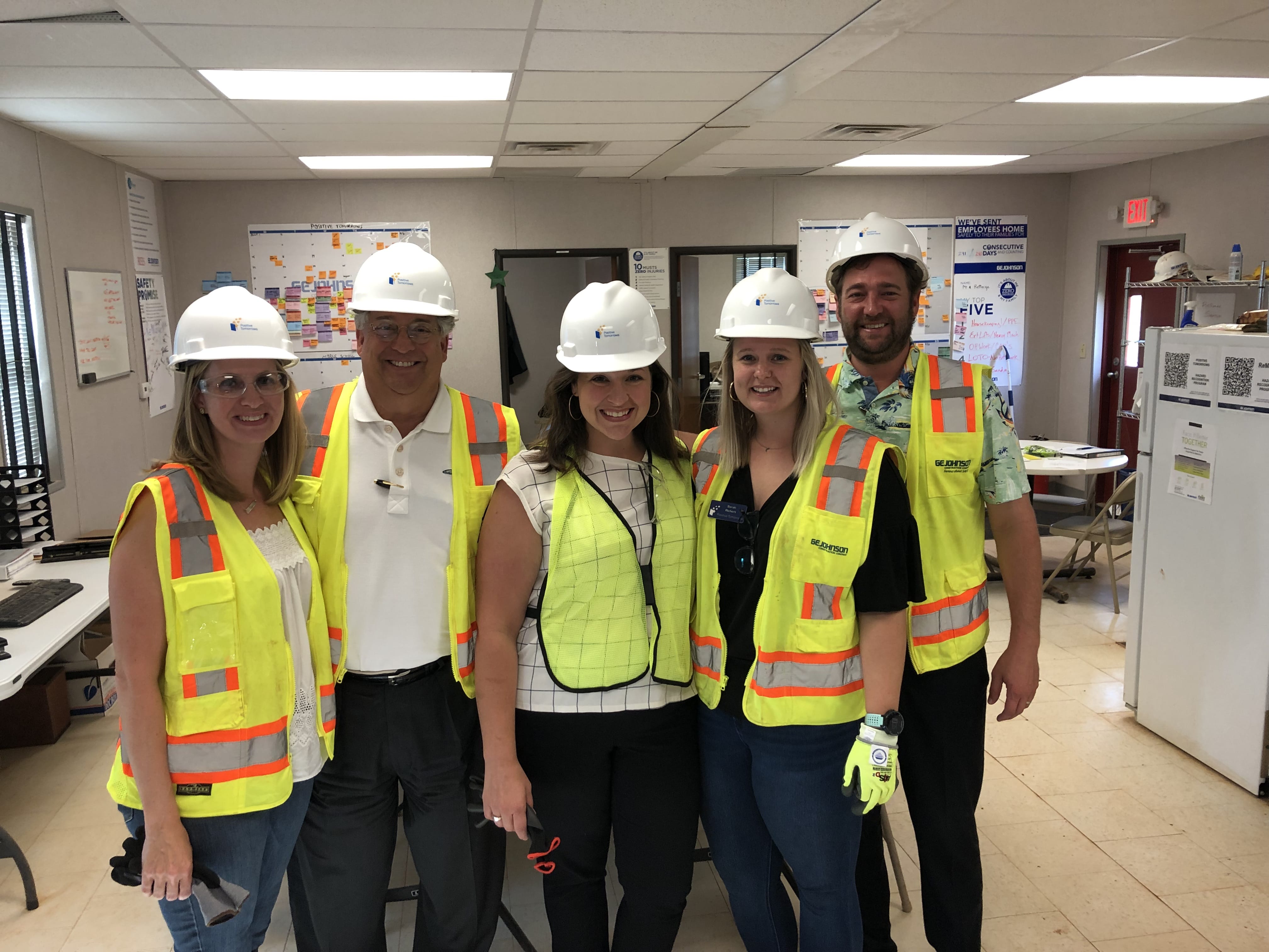 Frank, Will and Kari get a hard hat (and glove, safety vest and goggles!) tour of the new Positive Tomorrows building.
